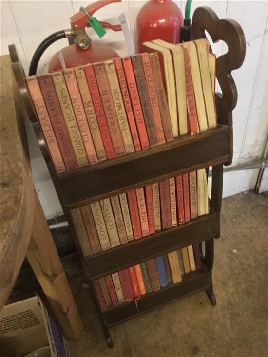 Quantity of Ward Lock Red Travel Guides in a low bookcase